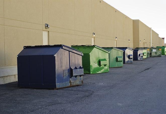 a crowd of dumpsters of all colors and sizes at a construction site in Cayucos CA